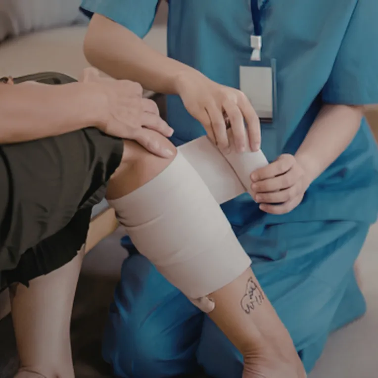 doctor wrapping a patients leg in wrap after an injury